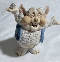 Front view of Trumph figurine showing overall design, colors and crystal