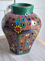 Front view of multicoloured perforated pottery vase