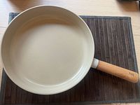 Top view of 11" frying pan showing interior ceramic coating and wooden handle