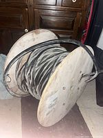 Full view of wooden reel with black coaxial cable wound
