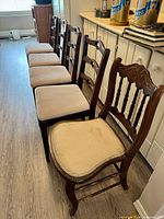 Group of four matching ladder-back chairs and one Eastlake chair lined up