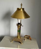 Full view of brass table lamp with shade and cord