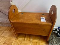 front view of pine bench showing heart cutouts, lid, hinges