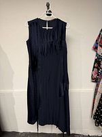 Front view of navy pleated sleeveless dress
