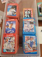 Stacks of 1988 Donruss red-border and 1990 Score blue-border cards in plastic bin