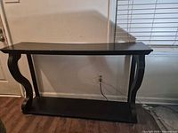 Front view of black console table against wall