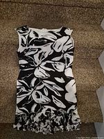 Full view of dress front showing floral print and sleeveless cut