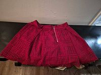 Front view of burgundy lace mini skirt on tabletop