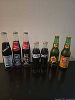 All seven sealed glass soda bottles lined up