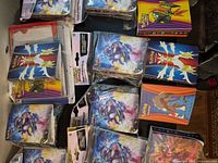Spread of sealed Greninja and Charizard mini portfolios on table