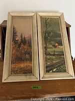 Both framed prints side by side on table