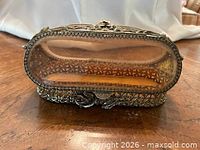 Front view closed showing gilt metal lattice, rose accent, beveled glass panels