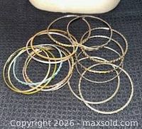 Group of mixed metal bangles on dark background