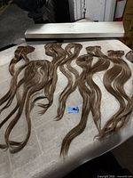 All seven hair extension pieces and Elegante box visible