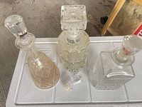 Three decanters with stoppers on cooler lid, loose stopper between