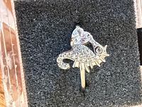 Front view of sterling silver seahorse ring with cubic zirconia and heart-shaped stone
