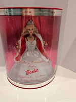Front view of boxed Barbie showing doll, gown, and red packaging