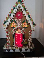 Front view showing candy details, red door with star cutouts, power cord