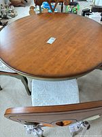 Top view of round table surface and one chair with seat pad