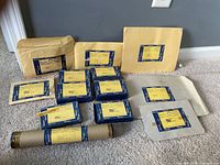 Group shot of all kit boxes, envelopes and mailing tube on carpet
