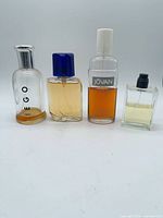 Group shot of four vintage men’s fragrance bottles