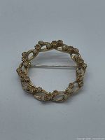 Front view showing openwork leaf pattern and cabochons