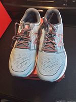 Top view of both shoes on box showing upper design, laces, logo
