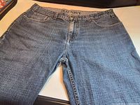 Full front view of jeans showing overall color, texture and cut
