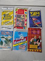 Front view of all six sealed trading card packs