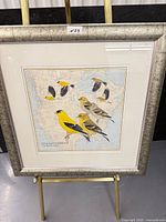 Full view of framed American Goldfinch print on easel