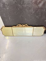 Full view of three-panel mirror showing frame and clipped corners