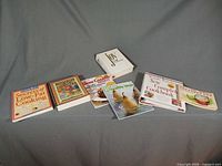 All cookbooks and magazines laid out spine up on grey backdrop