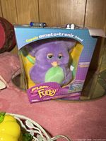 Boxed purple emoto-tronic Furby front view on tabletop