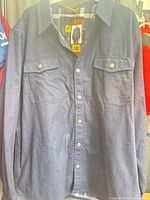 Front view of CAT navy shacket on hanger