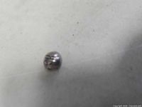 Small round silver bead showing recessed line pattern