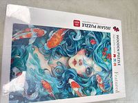 Front of sealed wooden jigsaw puzzle box showing mermaid and koi artwork