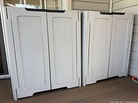 Front view of both white plastic cabinets closed