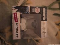 Front view of Buckbeak figure in retail box showing branding and character name