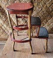 Overall view showing red metal seat, cream frame, two black steps