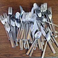 Pile of assorted flatware showing quantity and pattern