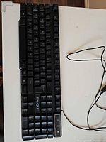 Top view of full keyboard showing T-WOLF branding, key layout, attached USB cable