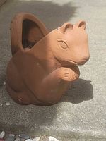 Front view of terracotta squirrel planter