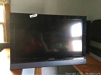 Front view of Vizio 26-inch TV showing screen and brand logo on bezel.