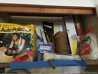 Photo showing the original box of the 12 Volt Auto Polisher and various ropes, mitre box, and saw grouped together.