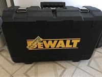 Closed black plastic DeWalt carrying case with handle and metal latches