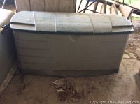 Closed Rubbermaid plastic deck box showing its size and condition.