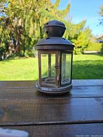 Front view of bronze metal candle lantern on table