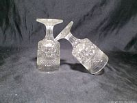 Two clear pressed glass cordial goblets showing overall form and pattern