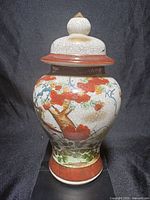 Front view of ginger jar with lid showing floral and bird motif