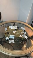 Overall view of all jewelry items on round glass table